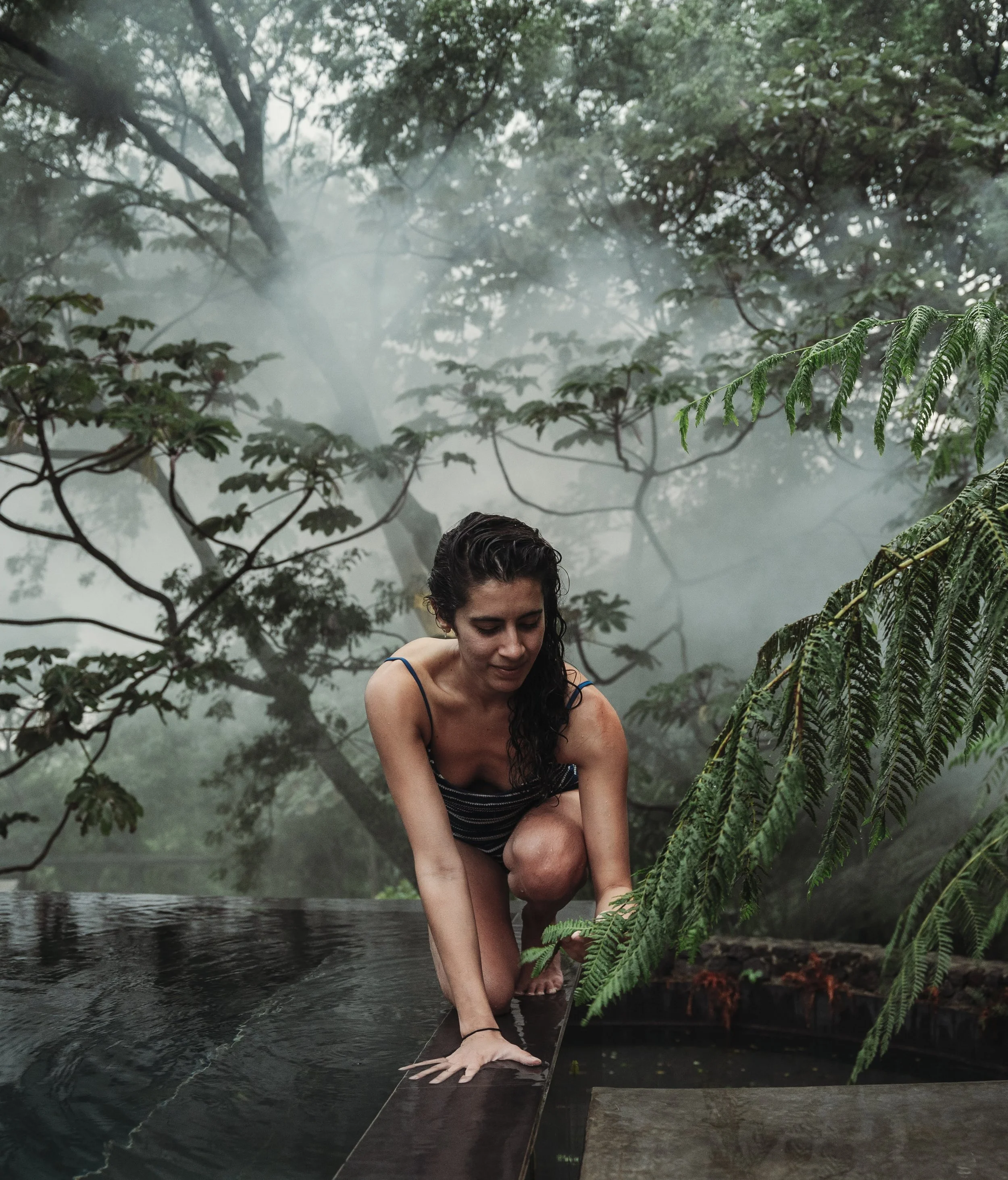Haneen Khan in a misty jungle setting, contemplative